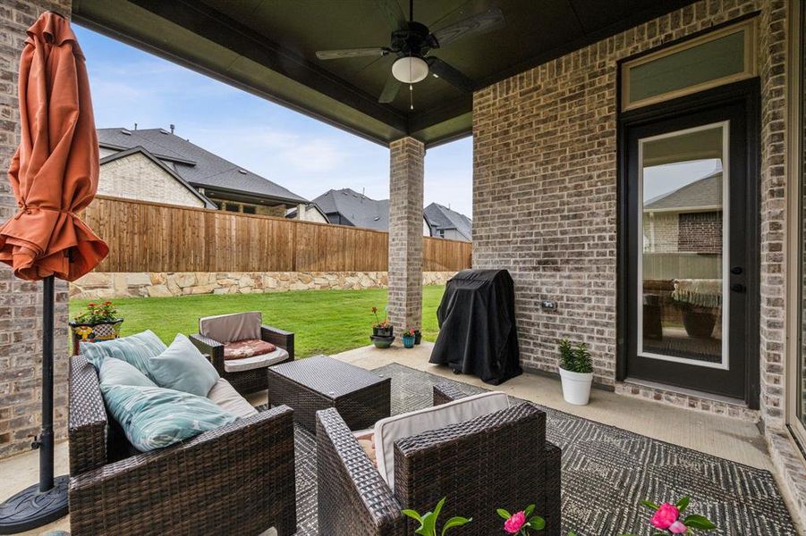 View of patio featuring ceiling fan and an outdoor living space