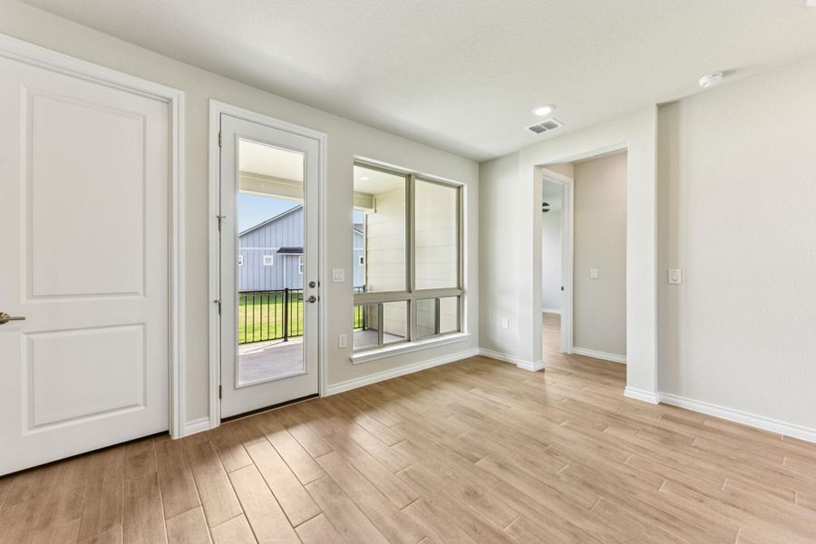 Entryway with wood finished floors and recessed lighting
