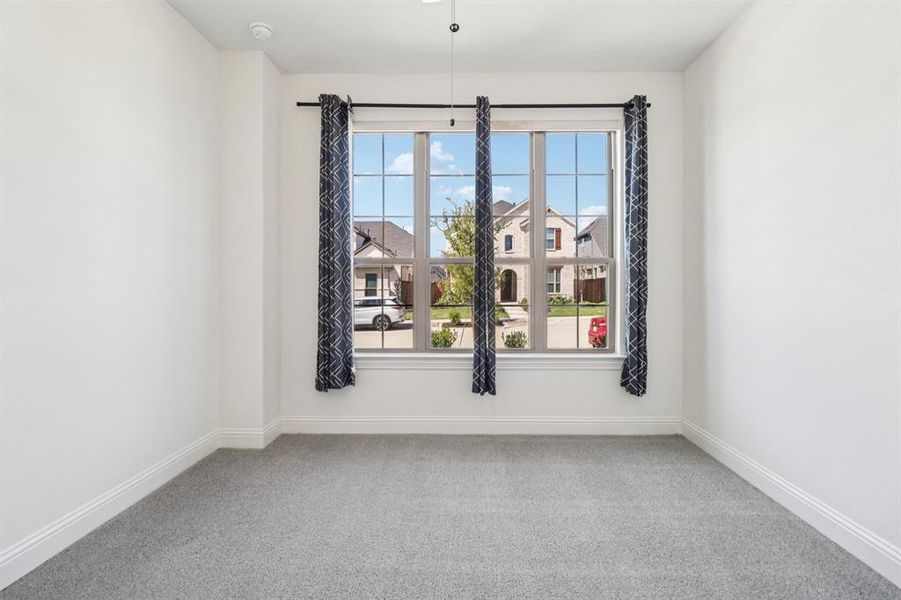 Carpeted empty room featuring baseboards Carpeted empty room featuring baseboards