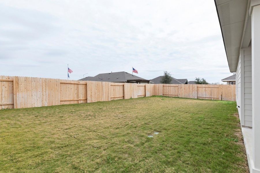 View of fenced backyard