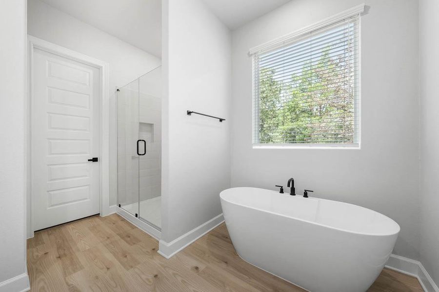 Master bathroom includes granite countertop, elongated mirror, and dual-vanity sinks. Relax in the large soaking tub or enjoy the spacious, standing shower.