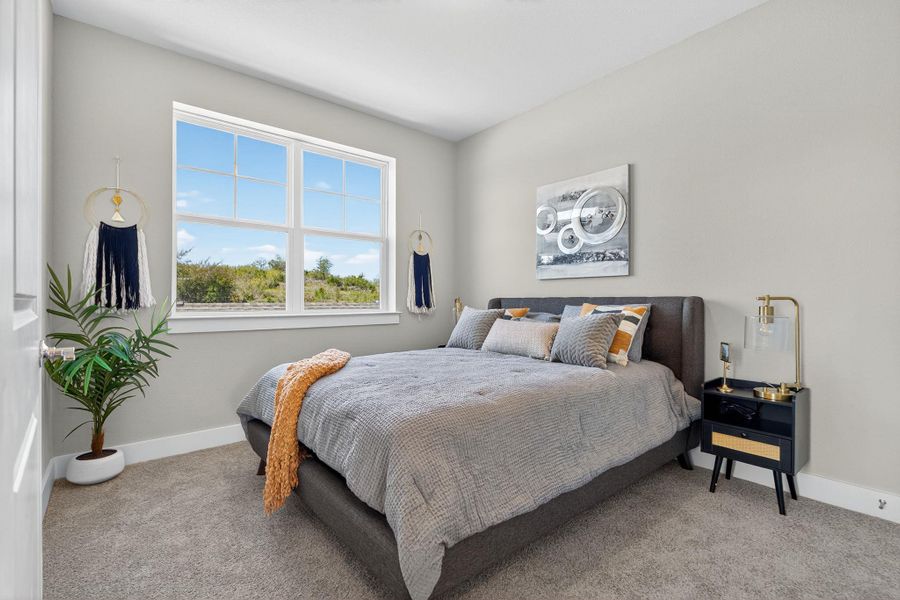 Bedroom featuring carpet flooring and baseboards