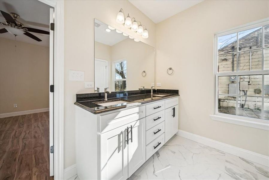 Bathroom featuring vanity, a wealth of natural light, and ceiling fan