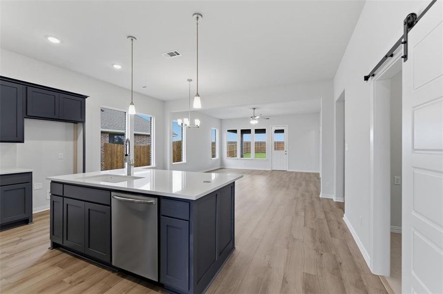 Kitchen island with sink and stainless steel dishwasher