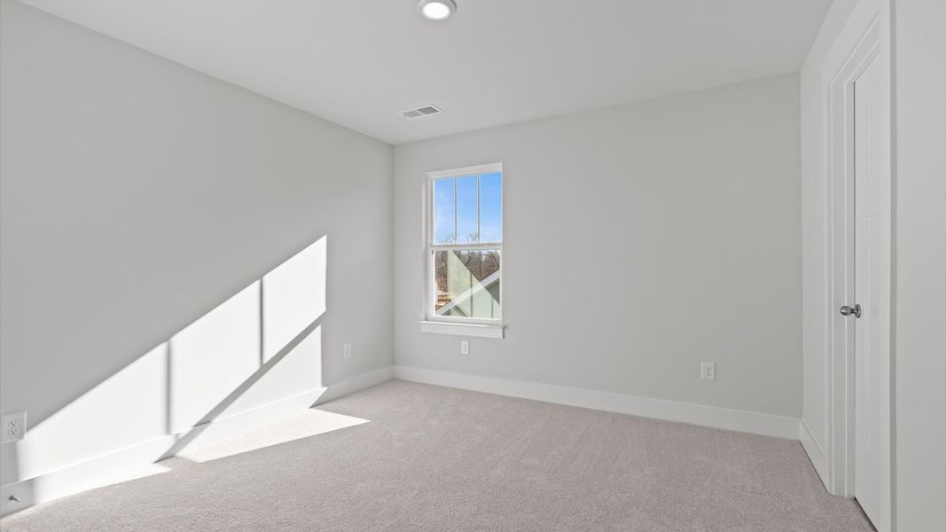 First-rate bedroom with plush carpeting and large windows that provide an open, airy feel