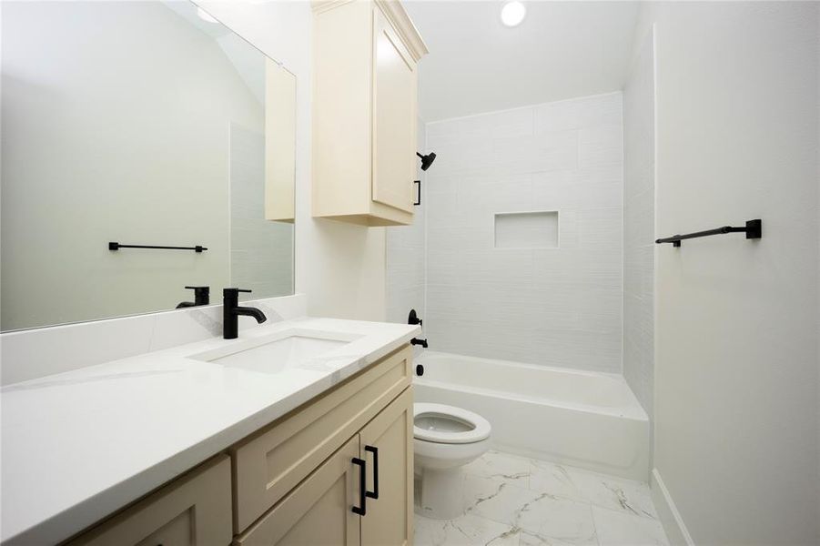 Full bath featuring vanity, shower / bathtub combination, light marble finish floors, and recessed lighting