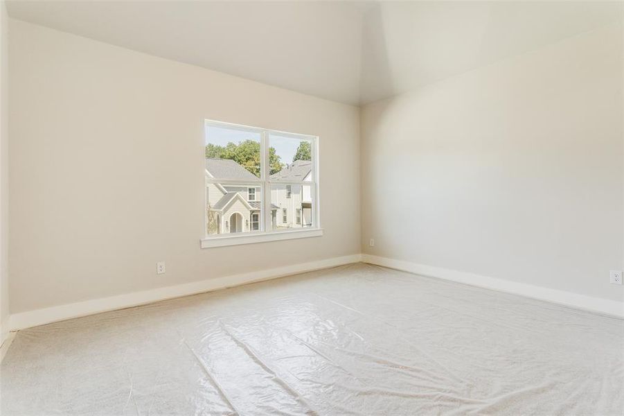 Spare room with carpet and lofted ceiling