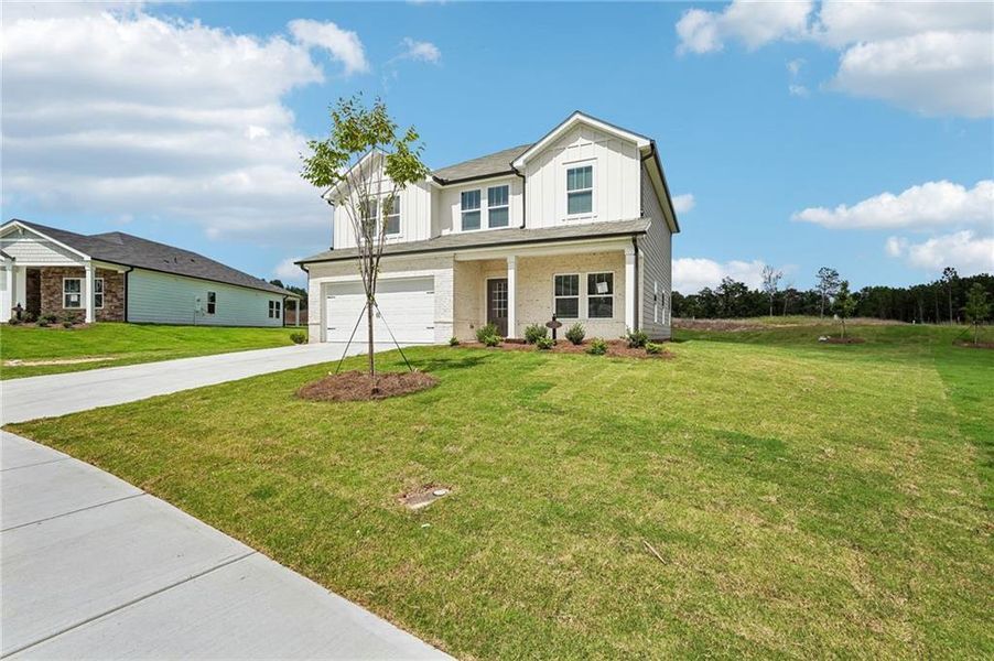Front exterior of a new home in Northwoods at Mirror Lake, Villa Rica, GA, highlighting curb appeal (Image 25).