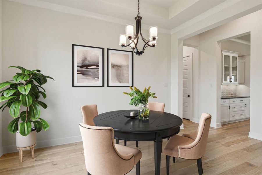 Dining space with a notable chandelier and light hardwood / wood-style floors *VIRTUAL STAGING