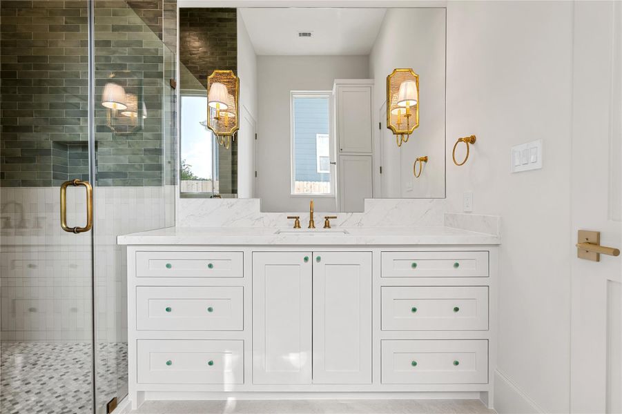 Fern colored tile & cabinet hardware provides the guest bathroom with a feeling of calm.