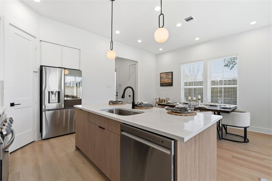 Clear sightlines to the dining area and entry hall reinforce the open-concept flow.