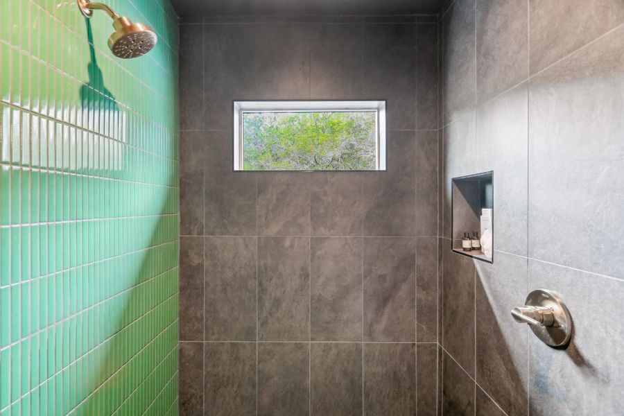 Bathroom featuring a tile shower Bathroom featuring a tile shower