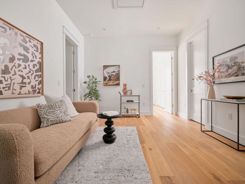 Living area featuring light wood-style flooring and baseboards Living area featuring light wood-style flooring and baseboards