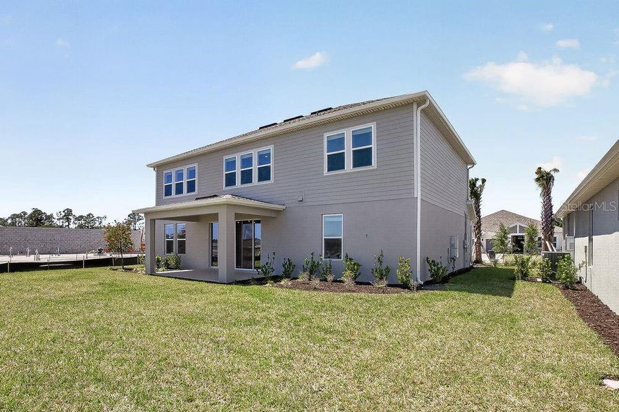 Exterior details and patio area of a home in Ardisia Park, New Smyrna Beach (Image 26).