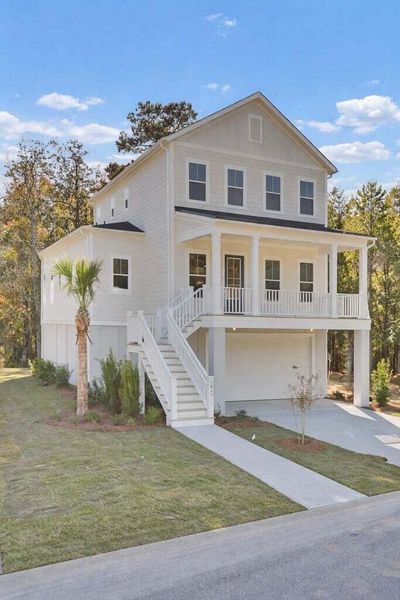 Front exterior of a new home in Indigo Grove Single Family Homes, Johns Island, SC, highlighting curb appeal (Image 2). Front exterior of a new home in Indigo Grove Single Family Homes, Johns Island, SC, highlighting curb appeal (Image 2).