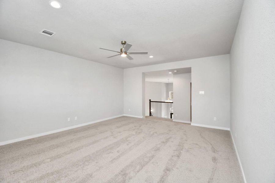Come upstairs and enjoy a day of leisure in this fabulous game room! This is the perfect hangout spot or adult game room! Features plush carpet, high ceilings, custom paint and windows for plenty of natural light. Sample photo of completed home with similar floor plan. Actual colors and selections may vary. Come upstairs and enjoy a day of leisure in this fabulous game room! This is the perfect hangout spot or adult game room! Features plush carpet, high ceilings, custom paint and windows for plenty of natural light. Sample photo of completed home with similar floor plan. Actual colors and selections may vary.