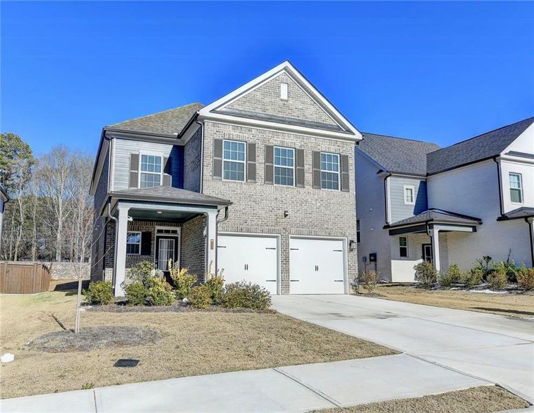 Front exterior of a new home in Graystone Village, Grayson, GA, highlighting curb appeal (Image 1). Front exterior of a new home in Graystone Village, Grayson, GA, highlighting curb appeal (Image 1).