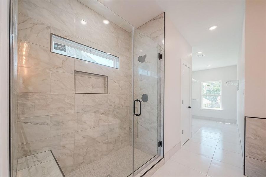 Luxury primary spa with fabulous tile to the ceiling