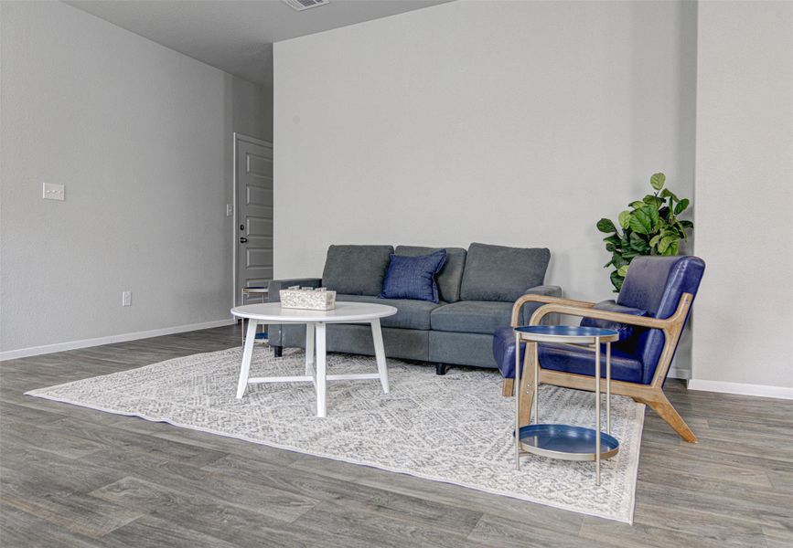 Neutral tones and rich wood flooring combine in this inviting living area. Neutral tones and rich wood flooring combine in this inviting living area.