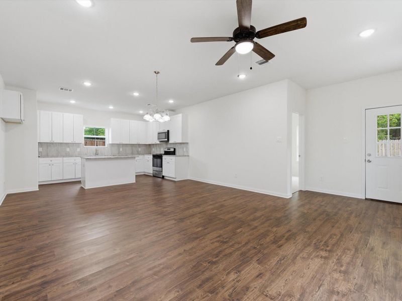 The spacious living room is designed for modern living, with soaring ceilings and an open-concept layout that keeps everyone connected.