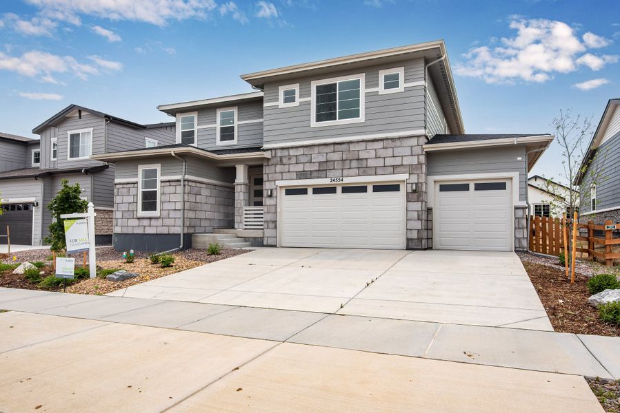 Front exterior of a new home in The Aurora Highlands, Aurora, CO, highlighting curb appeal (Image 2). Front exterior of a new home in The Aurora Highlands, Aurora, CO, highlighting curb appeal (Image 2).
