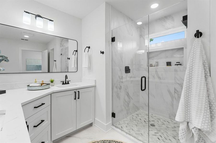 Bathroom with vanity and a shower with shower door Bathroom with vanity and a shower with shower door