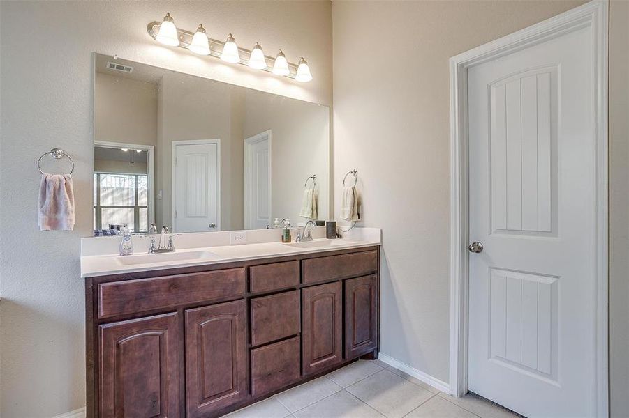 Bathroom featuring tile patterned floors and vanity