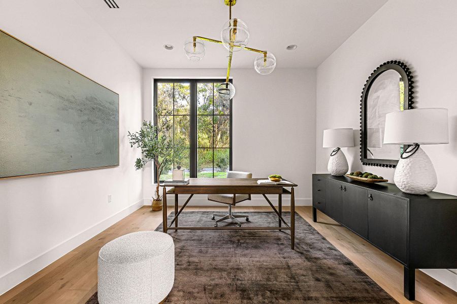 Sleek galley kitchen offers modern amenities and scenic outdoor views.