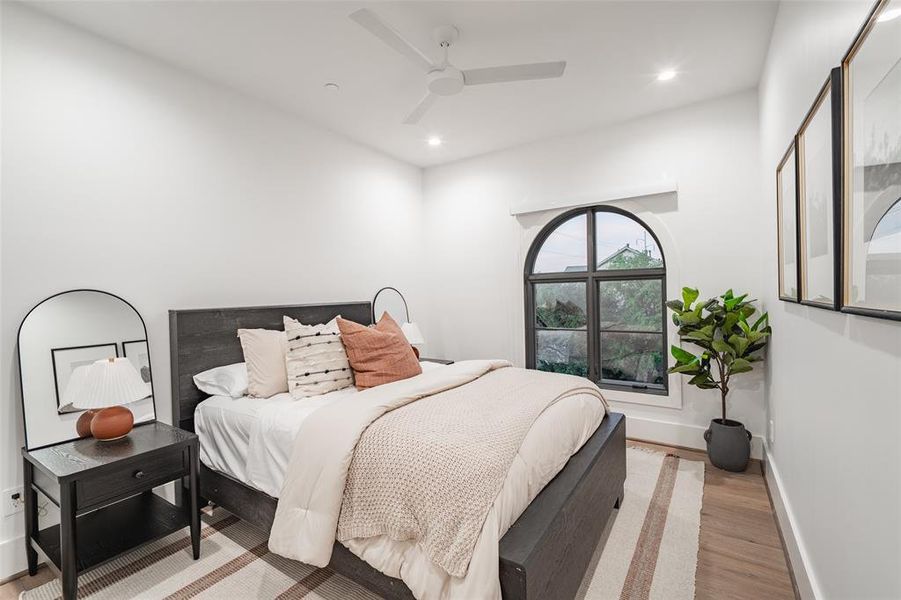 Bedroom with ceiling fan and light hardwood / wood-style floors