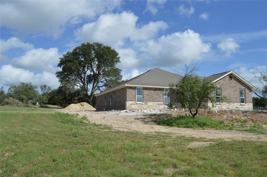 View of home's exterior with brick siding and a lawn View of home's exterior with brick siding and a lawn