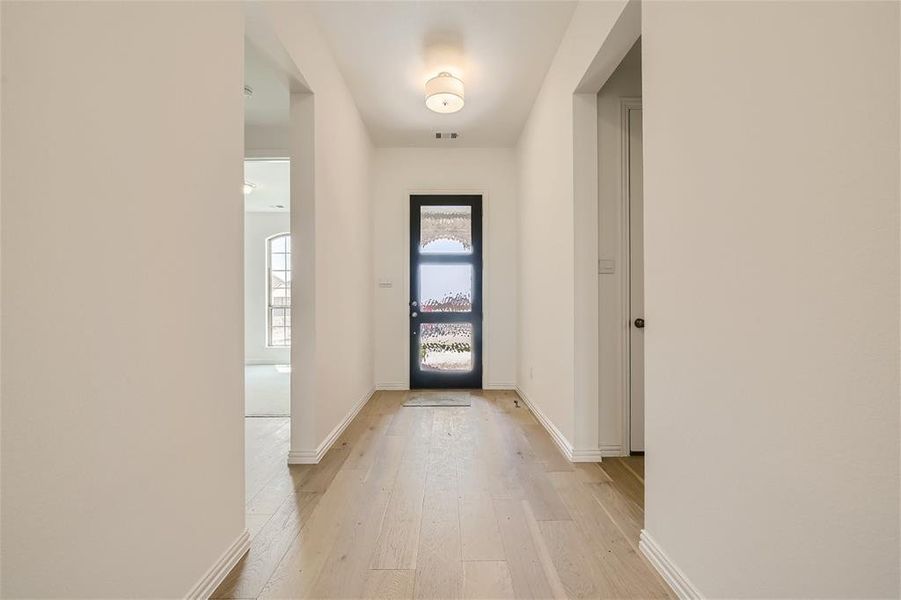 Doorway to outside with light wood-type flooring