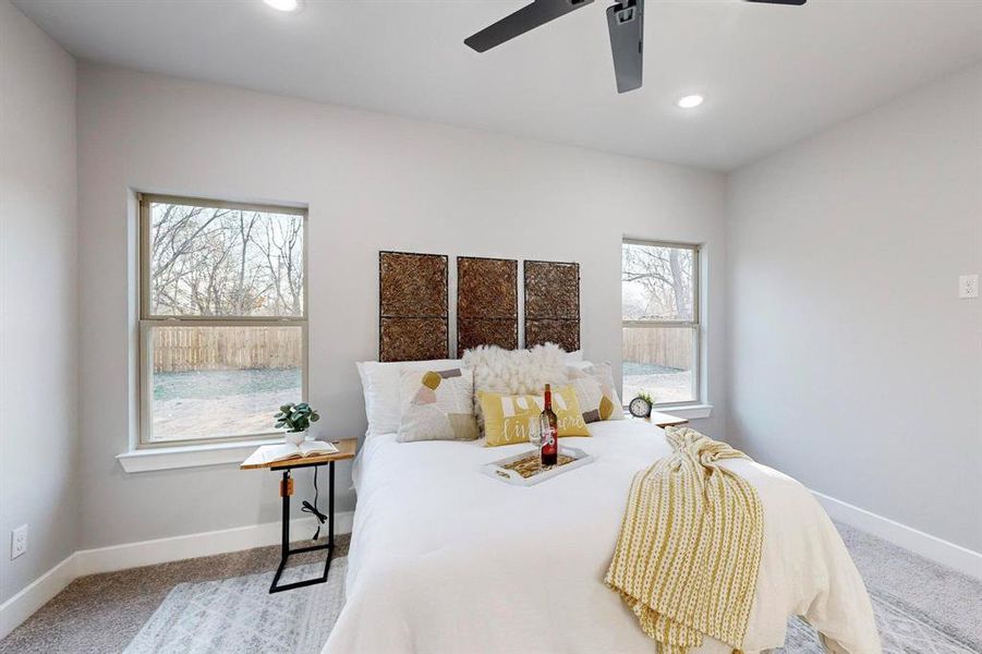 Bedroom featuring ceiling fan and carpet flooring