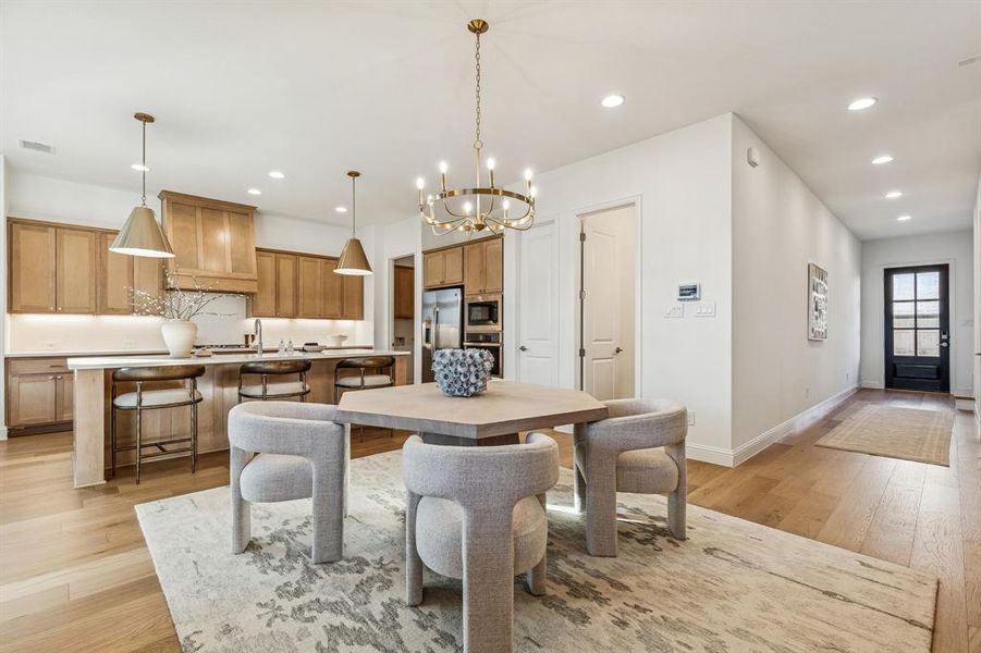 Dining room featuring hanging lights and light wood finished floors