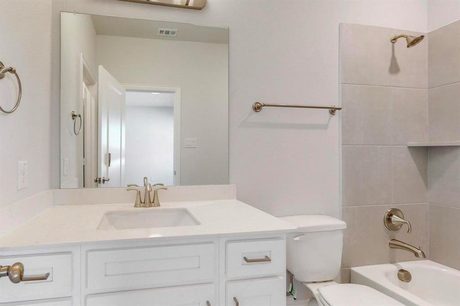 Bathroom with shower / washtub combination and vanity