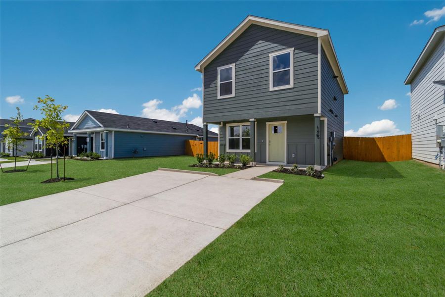 Front exterior of a new home in Marigold, Uhland, TX, highlighting curb appeal (Image 14). Front exterior of a new home in Marigold, Uhland, TX, highlighting curb appeal (Image 14).