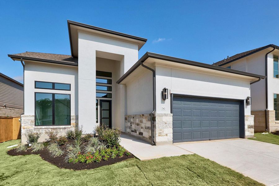 Front exterior of a new home in The Colony, Bastrop, TX, highlighting curb appeal (Image 23).