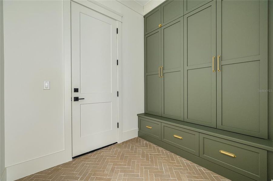 The door straight ahead leads to the garage. This is the mudroom with plenty of storage and cabinetry.