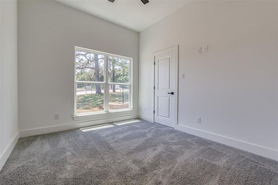 Empty room with a wealth of natural light and carpet