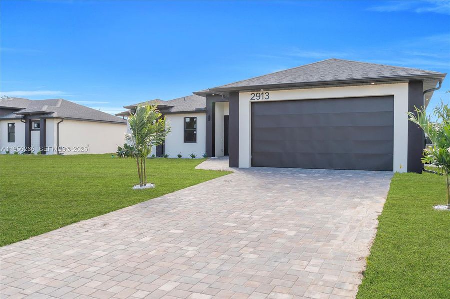 Front exterior of a new home in , Lehigh Acres, FL, highlighting curb appeal (Image 28).
