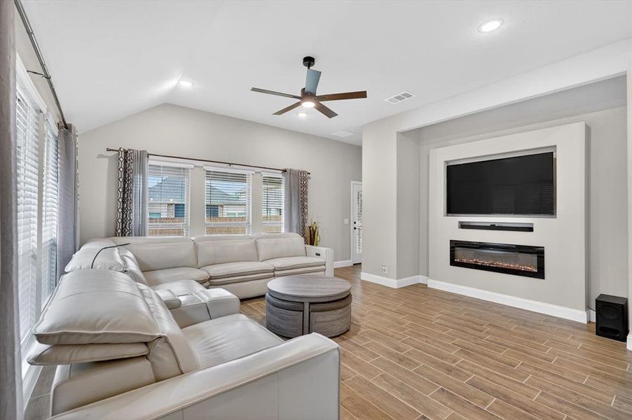 Living area featuring an accent wall with a built-in media niche and electric fireplace Living area featuring an accent wall with a built-in media niche and electric fireplace