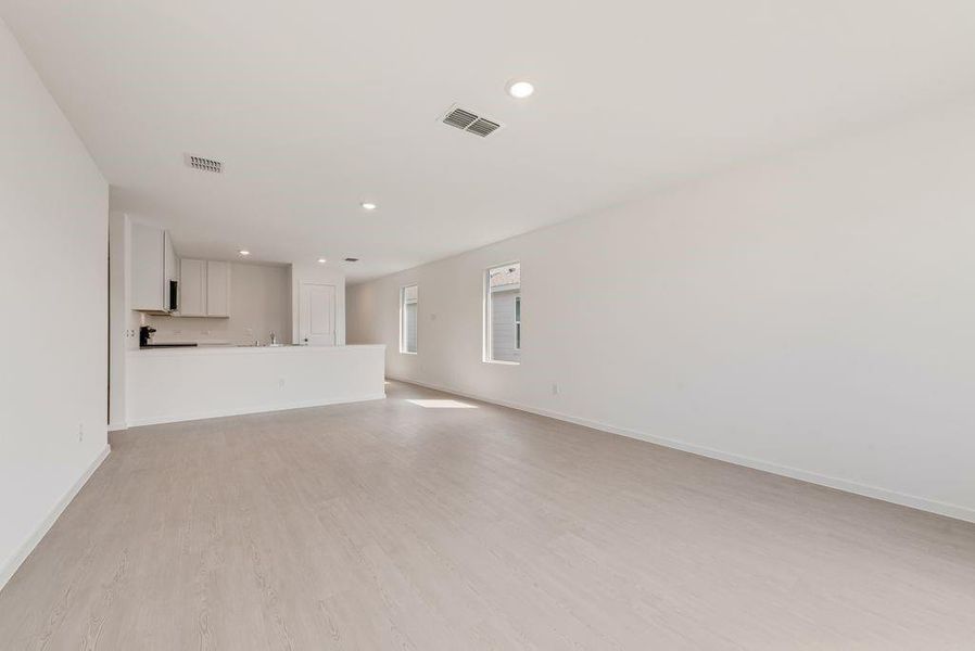 Unfurnished living room featuring light wood-type flooring and recessed lighting