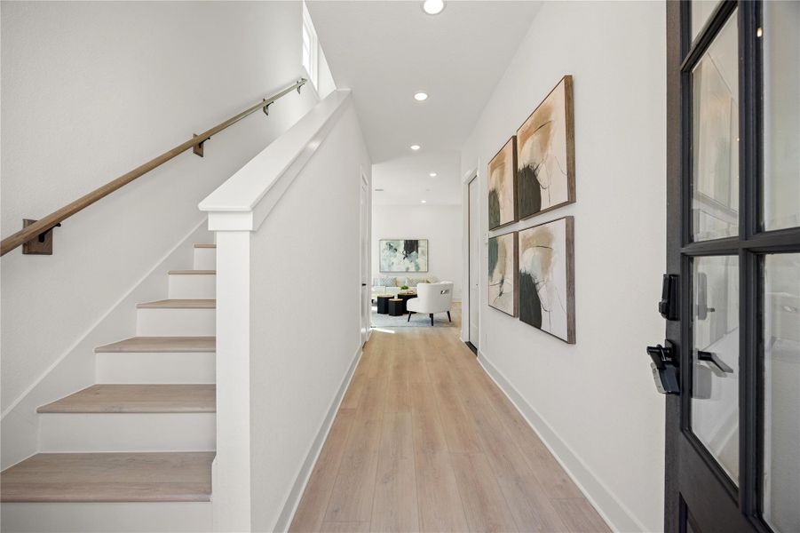 Walking into this gorgeous home, you get a feel of just how open and bright everything is. This space showcases soaring high ceilings, recessed lighting, custom paint for a cooling feel, staircase with beautiful wood handrail, and gorgeous wood flooring. This home is absolutely beautiful! Walking into this gorgeous home, you get a feel of just how open and bright everything is. This space showcases soaring high ceilings, recessed lighting, custom paint for a cooling feel, staircase with beautiful wood handrail, and gorgeous wood flooring. This home is absolutely beautiful!