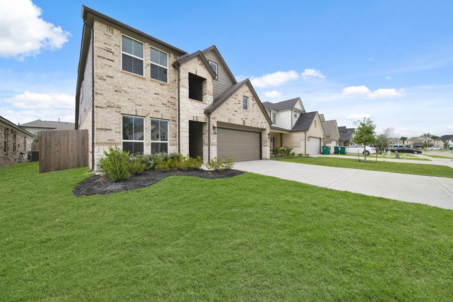 Front exterior of a new home in Barton Creek Ranch, Conroe, TX, highlighting curb appeal (Image 15). Front exterior of a new home in Barton Creek Ranch, Conroe, TX, highlighting curb appeal (Image 15).