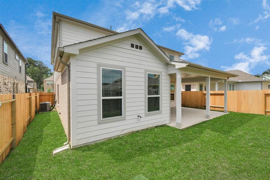 Backyard retreat, offering an abundance of space for kids to play and explore. The possibilities are endless in this outdoor haven, where the joy of open-air activities and family gatherings awaits. Sample photo of completed home with similar plan. As built color and selections may vary.