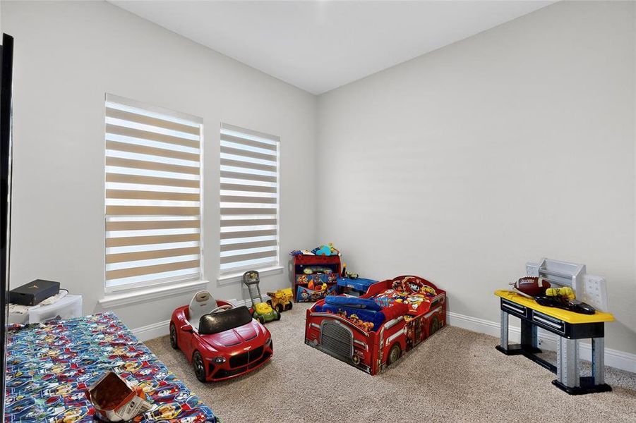 Carpeted bedroom featuring baseboards