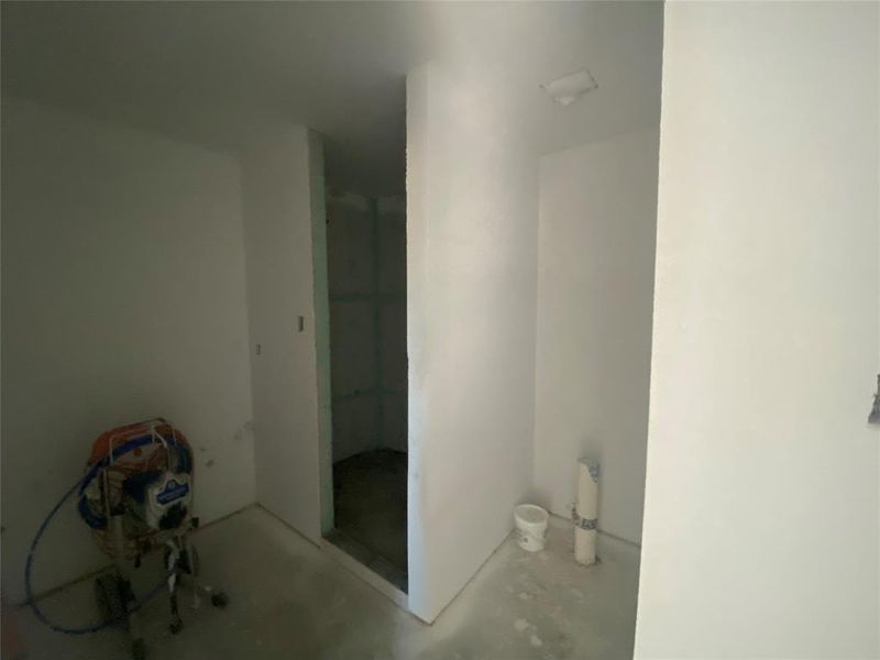 Full bath with concrete floors and a walk in shower