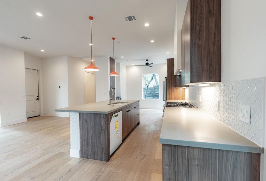 A well-appointed kitchen features a large island and ample counter space, seamlessly connecting to an open living area. A well-appointed kitchen features a large island and ample counter space, seamlessly connecting to an open living area.