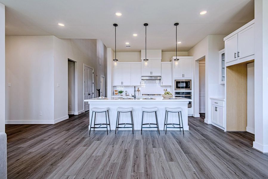 Spacious kitchen and dining area with wood-look flooring and an open layout