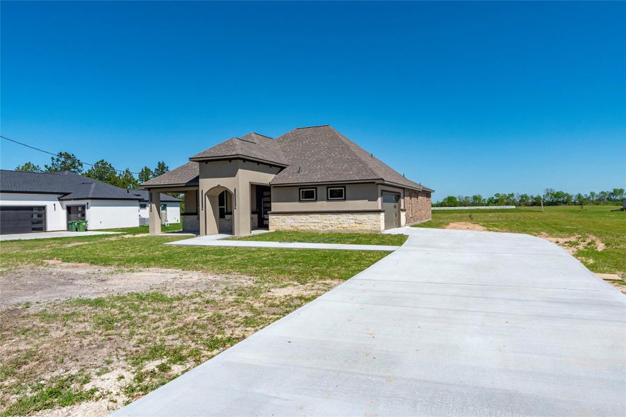 Front exterior of a new home in , Dayton, TX, highlighting curb appeal (Image 1). Front exterior of a new home in , Dayton, TX, highlighting curb appeal (Image 1).