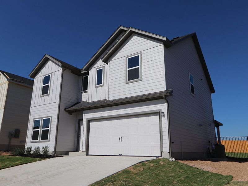 Front exterior of a new home in Cascades at Onion Creek, Austin, TX, highlighting curb appeal (Image 2).